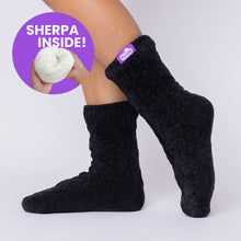Load image into Gallery viewer, The Foozie™ Move in Black, side view on foot with a 'Sherpa inside' badge showing the lining