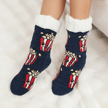 Load image into Gallery viewer, The Foozie™ Popcorn slipper socks, smiling popcorn box print on navy, worn on a fluffy white rug