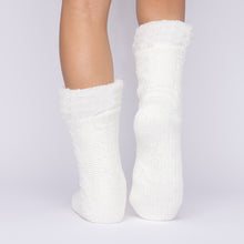 Load image into Gallery viewer, The Foozie™ in White, back view with one foot raised to show the sole