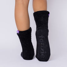 Load image into Gallery viewer, The Foozie™ Move in Black, back view showing the diamond cable knit and the foozie grips on the sole

