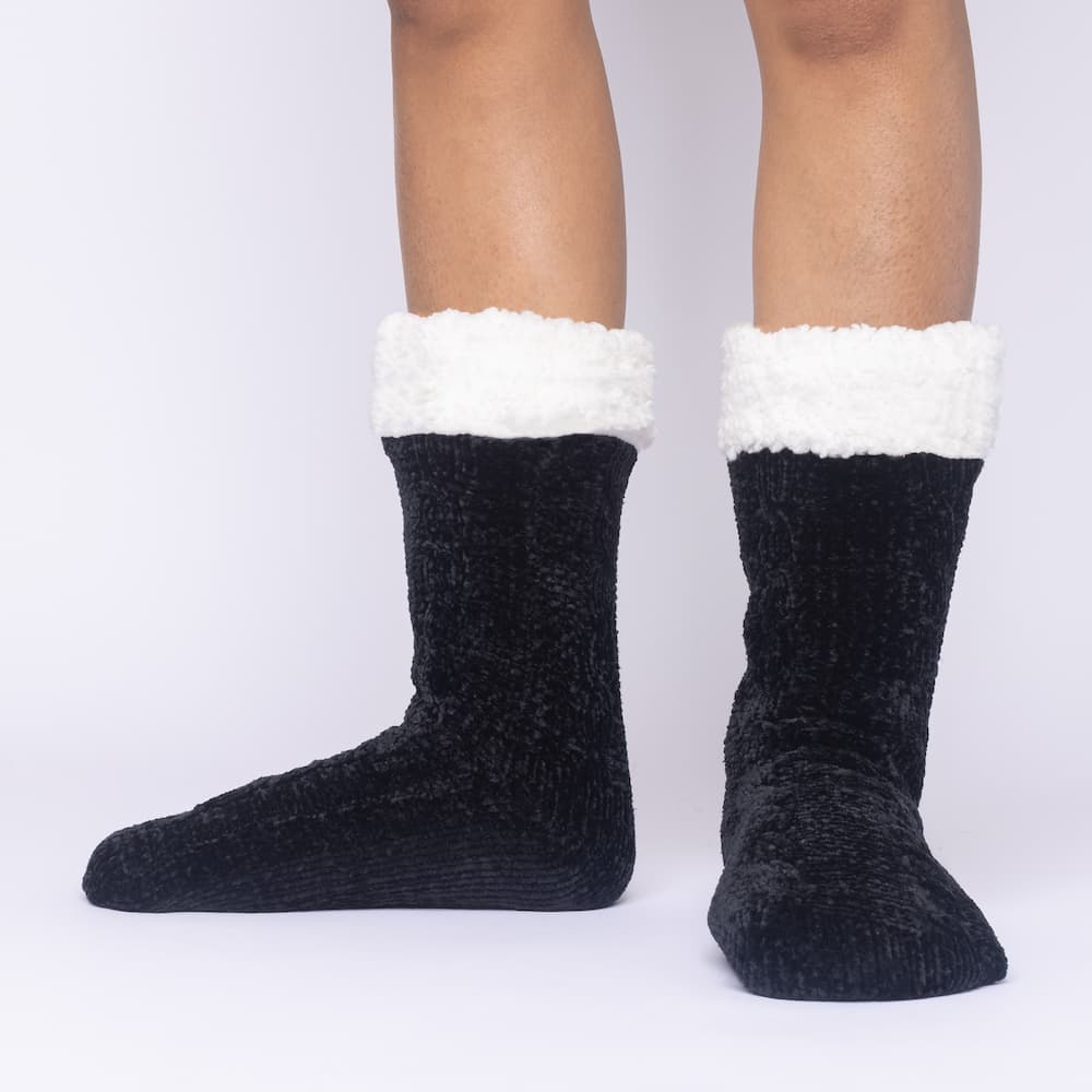 The Foozie™ in Black, front view of both feet worn in Medium with the sherpa cuffs folded down