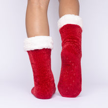 Load image into Gallery viewer, The Foozie™ in Red, back view with one foot raised to show the non-slip grips on the sole
