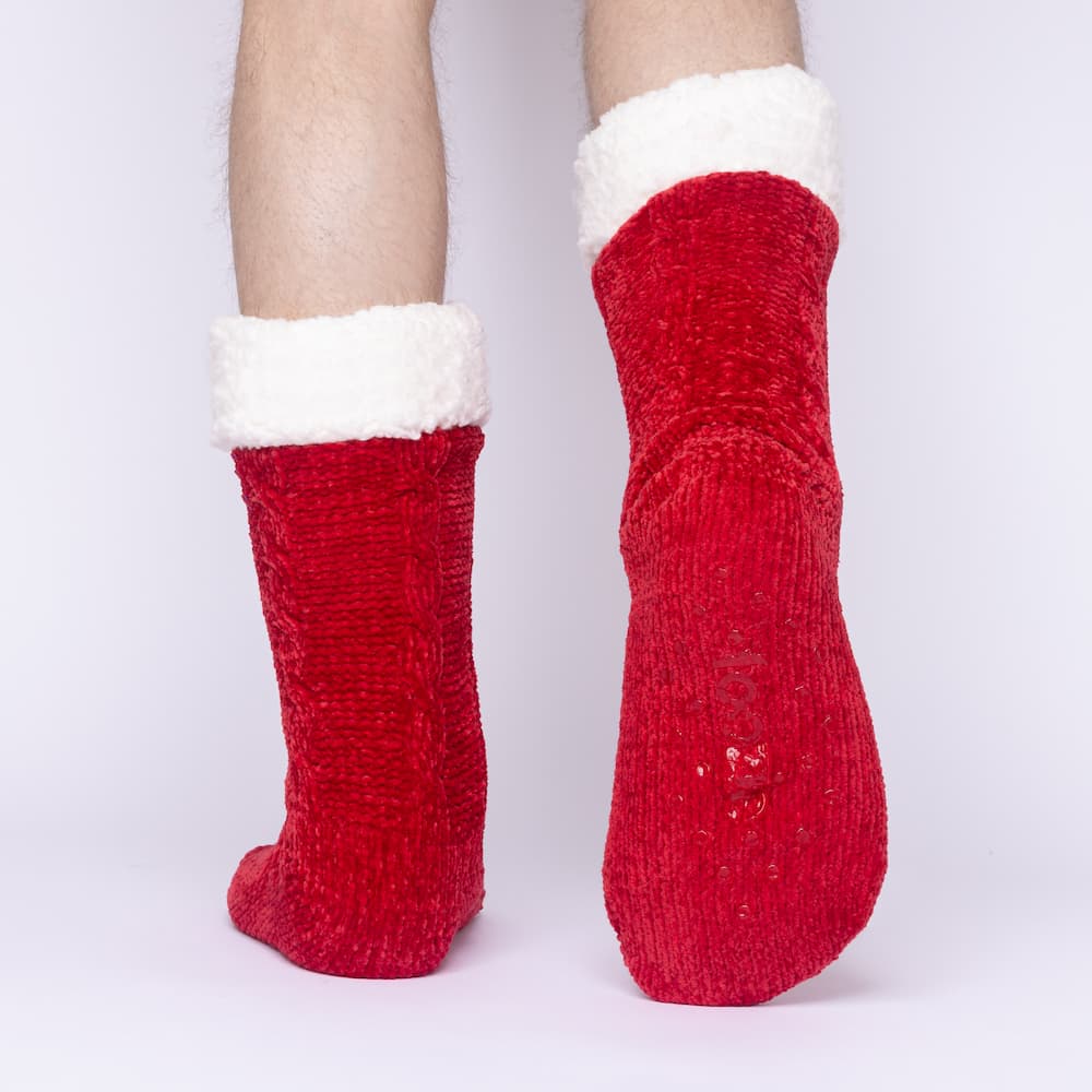 The Foozie™ in Red, back view worn by a man in Large with one foot raised to show the non-slip grips on the sole