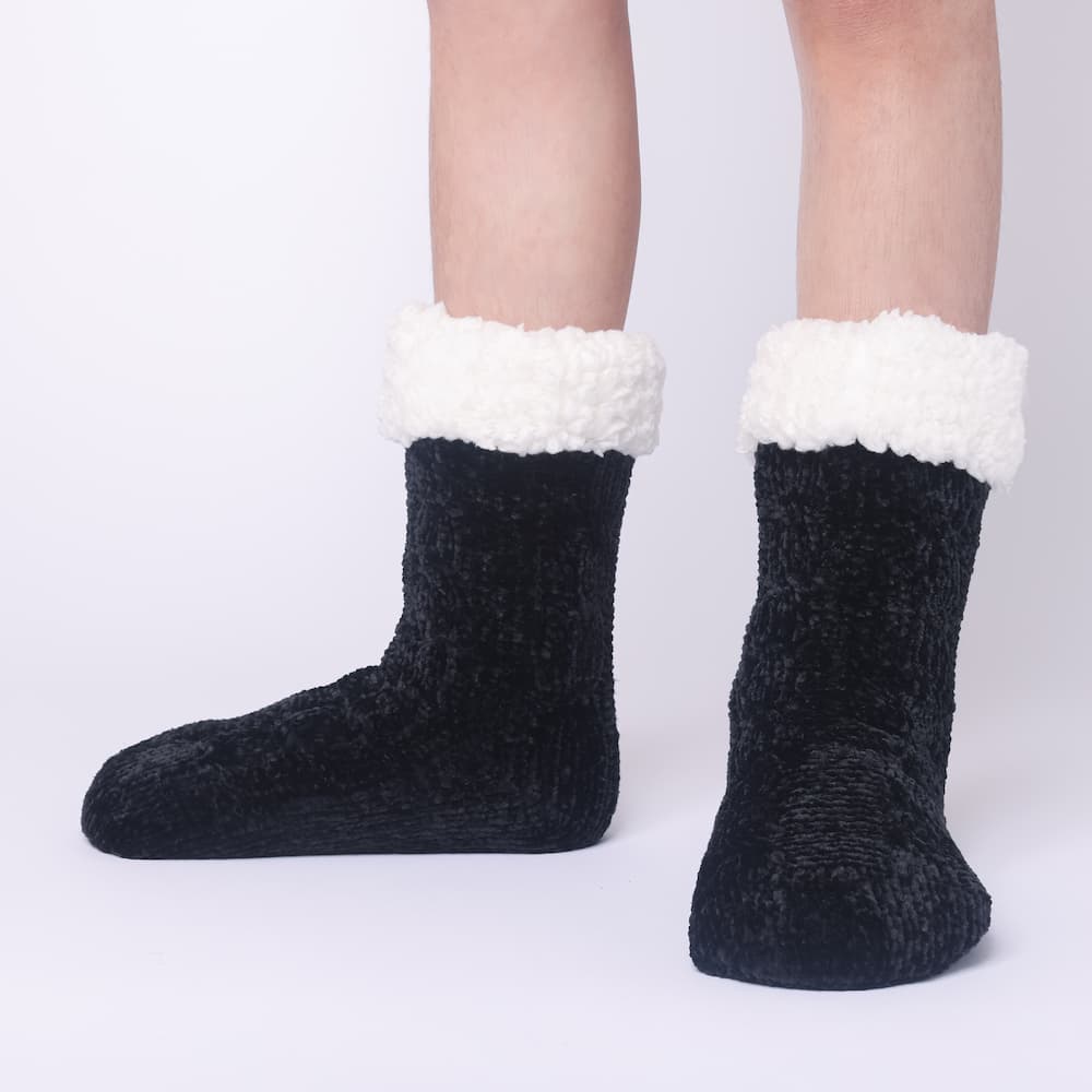 The Foozie™ in Black, front view of both feet worn in Kids/Small with the sherpa cuffs folded down