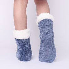 Load image into Gallery viewer, The Foozie™ in Blue, back view worn in Kids/Small with one foot raised to show the non-slip grips on the sole
